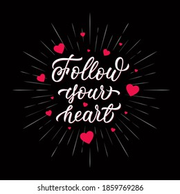 Follow your heart - inscription with pink hearts on black isolated background. Hand lettering design. Vector.