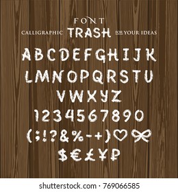 Font Trash, a painted white paint, with lime, on a dark wooden background, illustration, vector