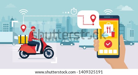 Food delivery app on a smartphone tracking a delivery man on a moped with a ready meal, technology and logistics concept, city skyline in the background