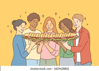 Food, friendship, togetherness, happiness, hunger concept. Group of young international multiethnic friends african american women men sharing large sandwich together. Meal for breakfast lunch dinner.