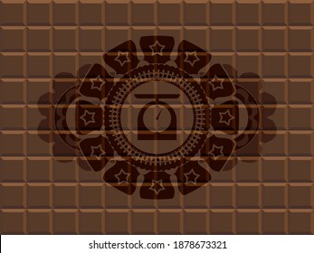 food scale icon inside chocolate realistic badge. Brown fancy background. Artistic illustration. 