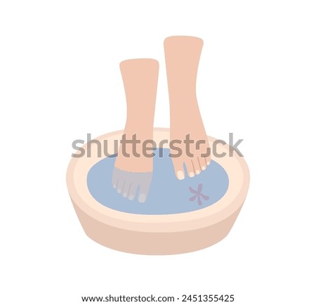 Foot bath with natural floral elements. Beauty salon and foot bath. Female legs during massage.