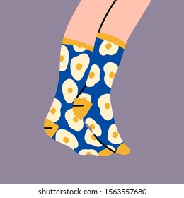 Foot, feet. Pair of female or male legs in the socks. Cool design. Sunny side up egg print. Stylish underwear. Fashion accessories. Footwear. Hand drawn vector colored trendy illustration. Flat design