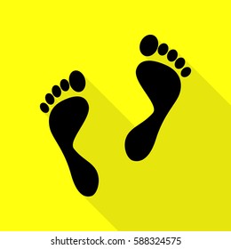 Foot prints sign. Black icon with flat style shadow path on yellow background.
