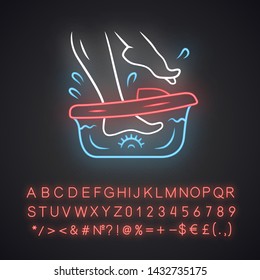Foot spa bath massager neon light icon. Relaxing massage. Beauty device for home use. Beauty parlour chiropody procedure. Glowing sign with alphabet, numbers and symbols. Vector isolated illustration