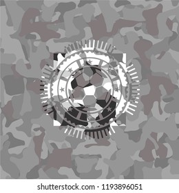 football ball icon inside grey camouflaged emblem