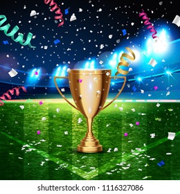 Football cup in the soccer arena on a background of grass field. The moment of victory with confetti around night background football field stadium and fans 2018 soccer cup