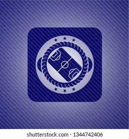 football field icon inside badge with denim texture