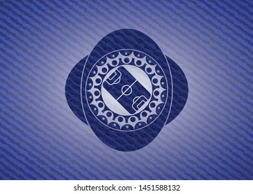 football field icon inside badge with denim texture