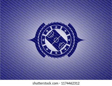 football field icon inside emblem with denim texture