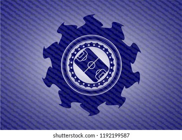 football field icon inside emblem with denim texture