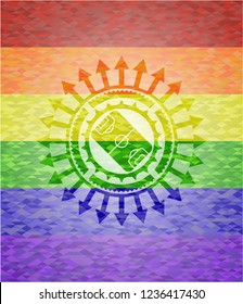 football field icon inside emblem on mosaic background with the colors of the LGBT flag