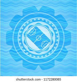 football field icon inside water representation emblem.