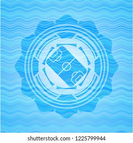 football field icon inside water representation emblem.
