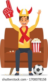 Football match supporting. Man celebrating goal. Sport fan sits on the sofa. Vector stock