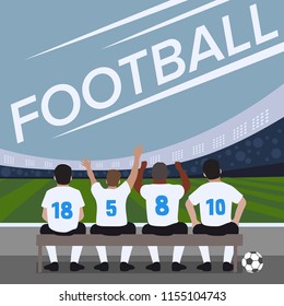 Football soccer match. Football players waiting on a bench.