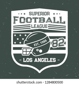 Football vintage grunge T-shirt print design of rugby ball and player helmet with American flag. Vector American Los Angeles football league or team badge