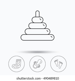 Footprint, pacifier and socks icons.