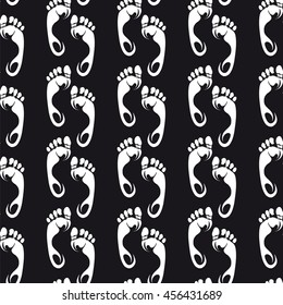 Footprints seamless pattern vector. Chalk footprints on black background