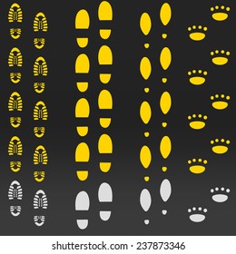 Footsteps on the road of different people. Yellow on the black background. Can be used as template for your own brush. Footprints.