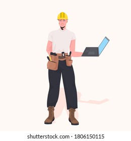 foreman in helmet using laptop working at construction site repair service concept full length vector illustration