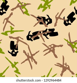 Forest camouflage of various shades of beige, black, green and brown colors. It is a colorful seamless pattern that can be used as a camo print for clothing and background and backdrop or wallpaper