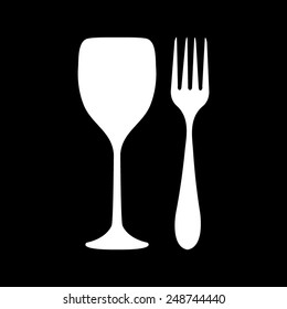 Fork and glass on a black background