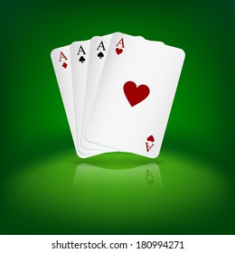 Four aces playing cards on green background