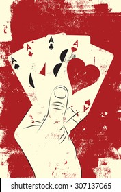 Four aces poker hand
Hand holding four aces over a textured background. 
