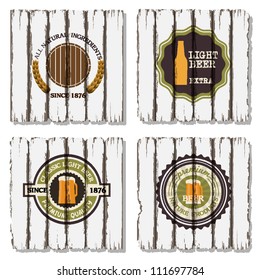Four beer labels on old wood background
