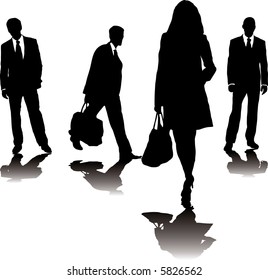 four business people in silhouette walking in different directions