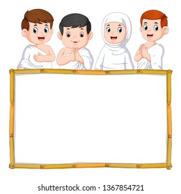 the four children are using the white cloth above the wooden banner