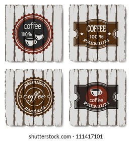 Four coffee labels on old wood background