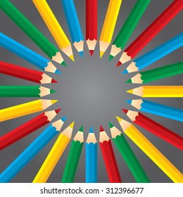 Four colored pencils like rays on a dark background