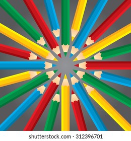 Four colored pencils like rays on a dark background