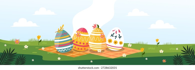 four colorful patterned easter eggs placed on picnic blanket in garden field