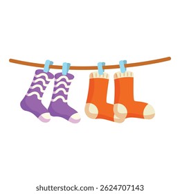 Four colorful socks hanging on clothesline drying after laundry