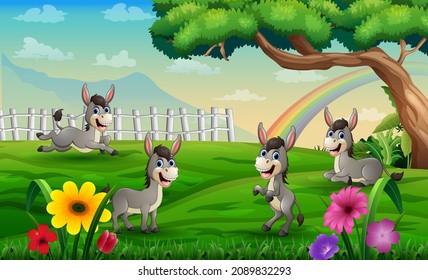 Four donkeys playing in the meadow on a rainbow background