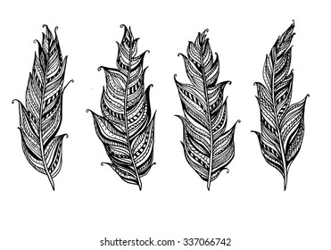 Four hand drawn doodle ornamental feathers. Vector ethnic decorative elements isolated on white background. Creative hipster print template.