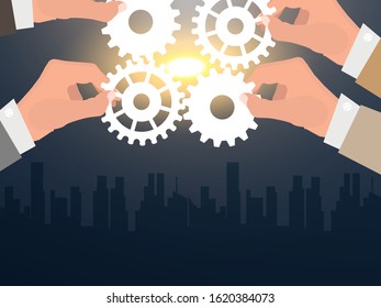 Four hands of businessmen collect gear from the gears of the details of puzzles. against the background of sunlight. The concept of a business idea. Teamwork. strategy. cooperation
