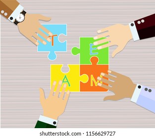 
Four hands putting multicolor puzzle pieces together. Teamwork, cooperation, business, solution, work concept. 