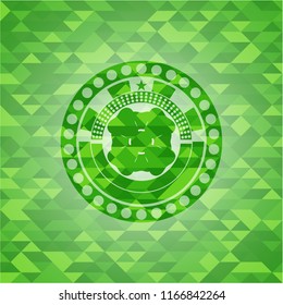 four leaf clover icon inside green emblem with triangle mosaic background