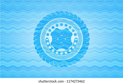 four leaf clover icon inside water wave representation emblem.