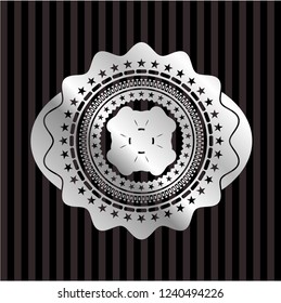 four leaf clover icon inside silver emblem or badge