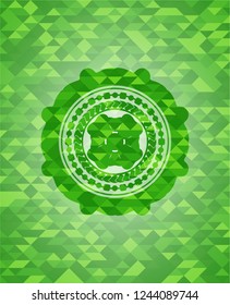 four leaf clover icon inside green emblem with triangle mosaic background