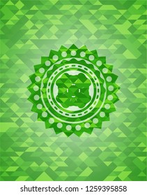 four leaf clover icon inside green mosaic emblem