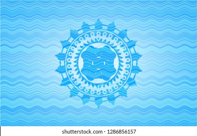 four leaf clover icon inside sky blue water wave style emblem.