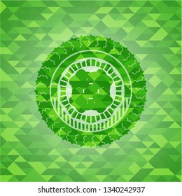 four leaf clover icon inside green emblem with mosaic ecological style background