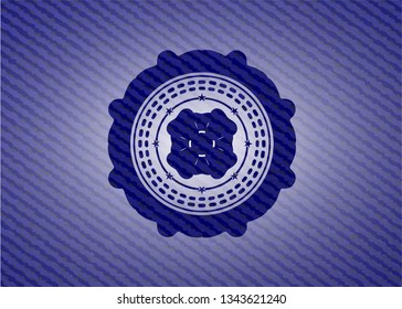 four leaf clover icon inside emblem with jean background