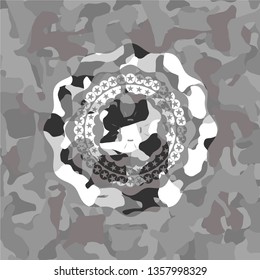 four leaf clover icon inside grey camouflaged emblem